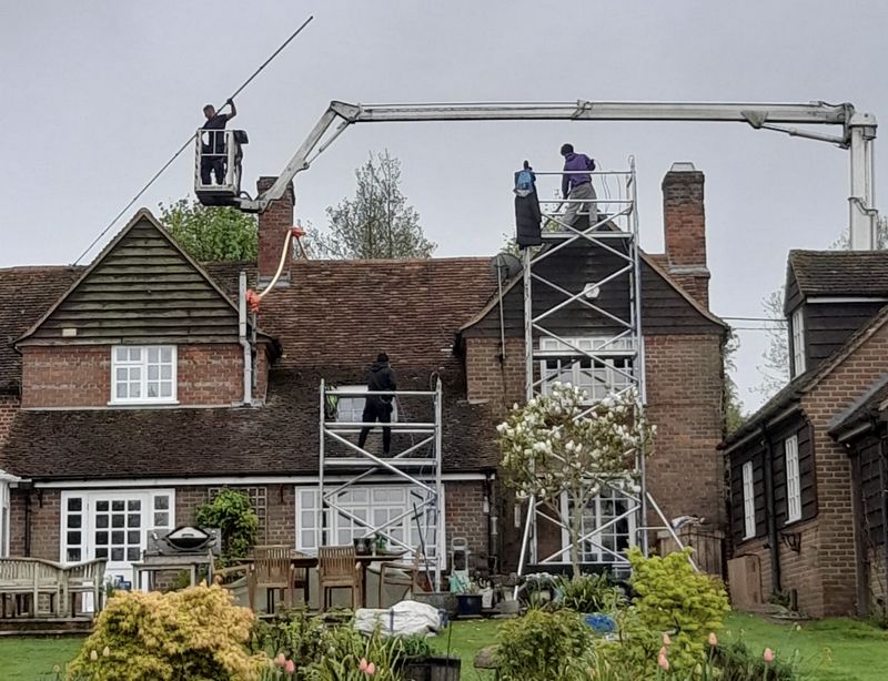 The Moss Cleaners using cherry picker and scaffolding to clean roof safely and professionally in Wandsworth, London